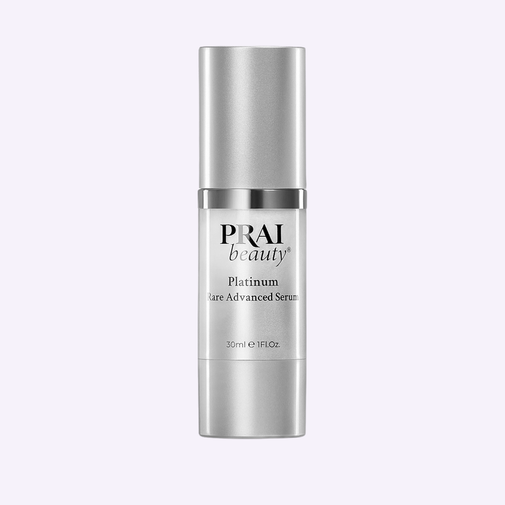 Silver skincare serum bottle with 'PRAI beauty' branding on a white background